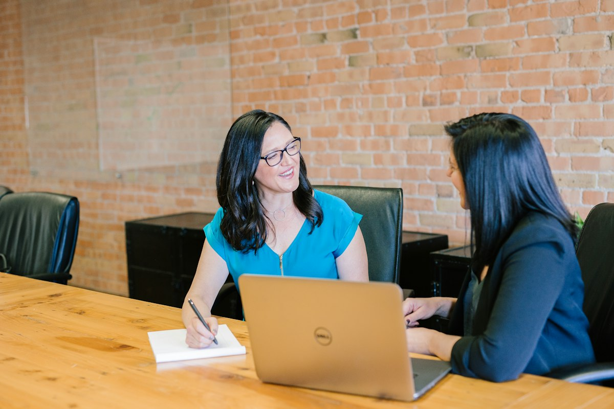 Small business owner reviewing automated AI draft output on laptop